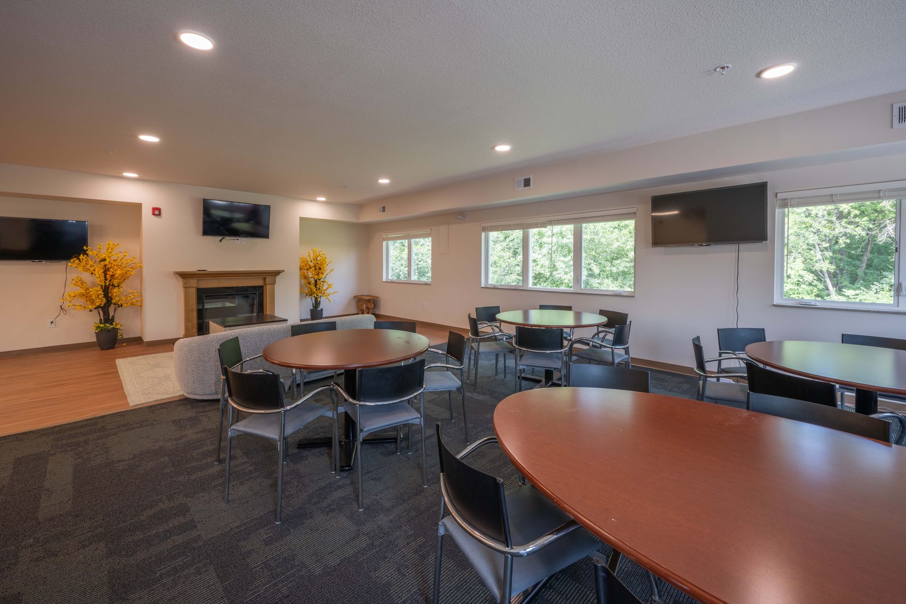 Community room with fireplace and garden views