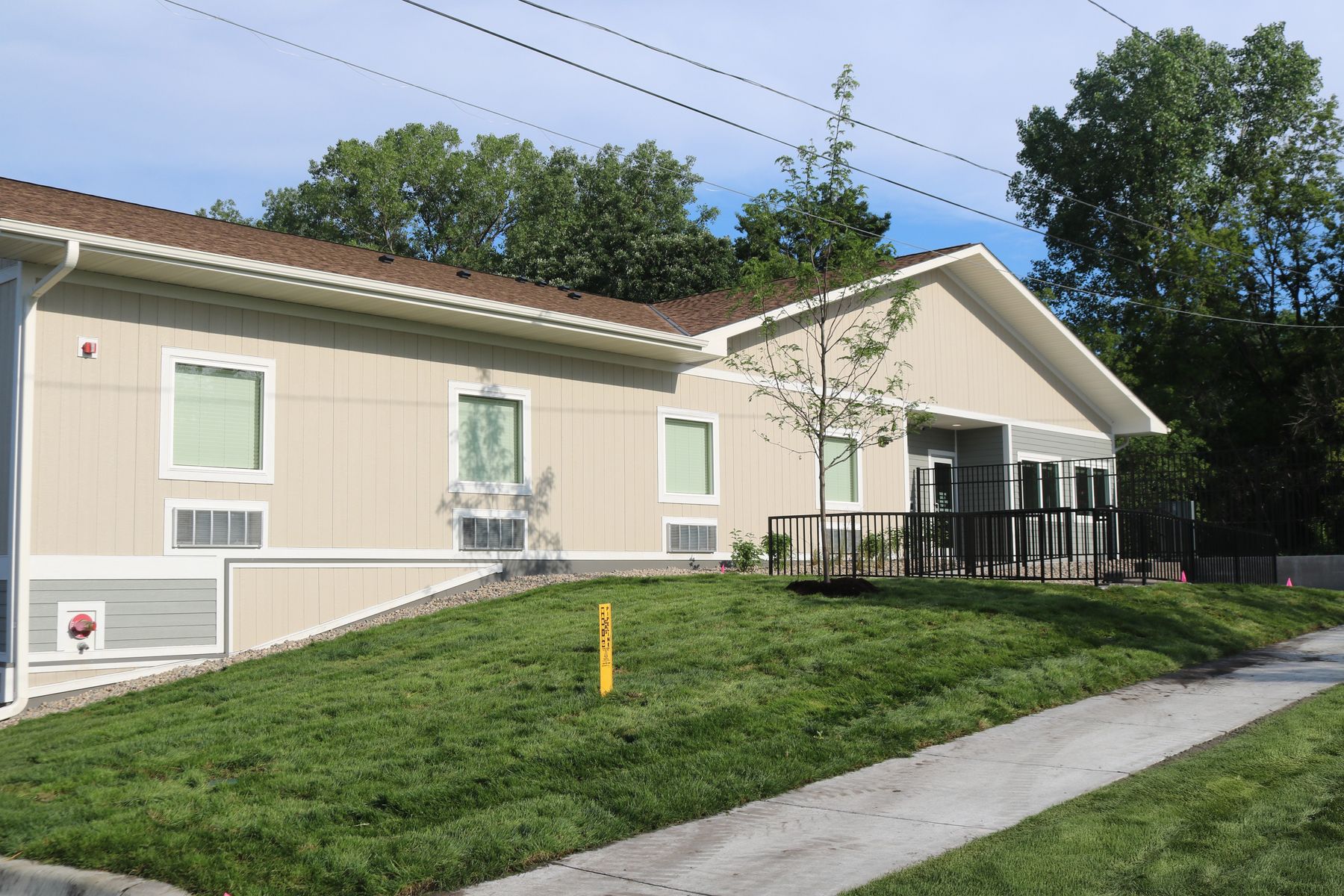 Building exterior with lawn and accessible ramp